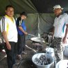 Volunteers cook in a tent kitchen - Ternate