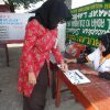 A woman votes in the election - Aceh