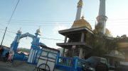 A gold-dombed mosque rising between two churches in Bajawa, in largely Catholic Flores