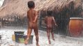 Kids in Tarong village, West Sumba, play in the rain