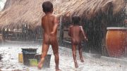 Kids in Tarong village, West Sumba, play in the rain