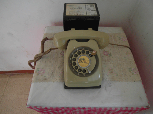 Ancient rotary phone under lock and key